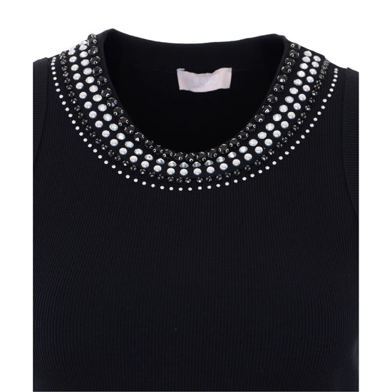 Canottiera nera con borchie bianche e nere