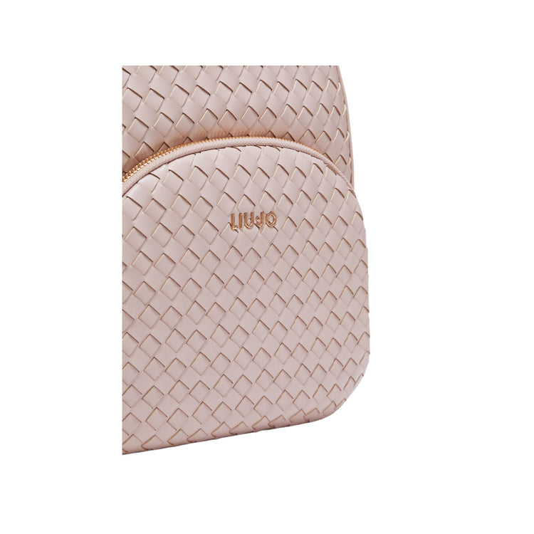 Dettaglio ravvicinato tasca frontale con zip ed effetto nappa intrecciata colore Rosa
